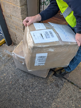 Emerald Logistics team member carefully handling a wrapped parcel