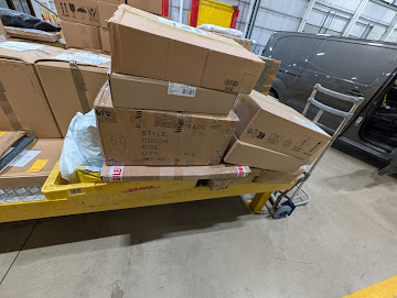 Emerald Logistics warehouse depot with boxes on trolley ready for delivery