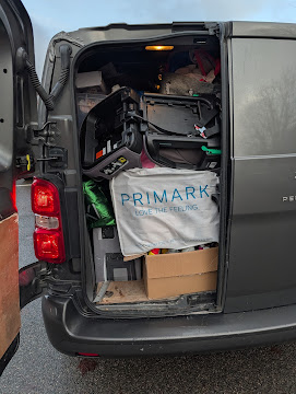 Rear view of Emerald Logistics van fully loaded with household items